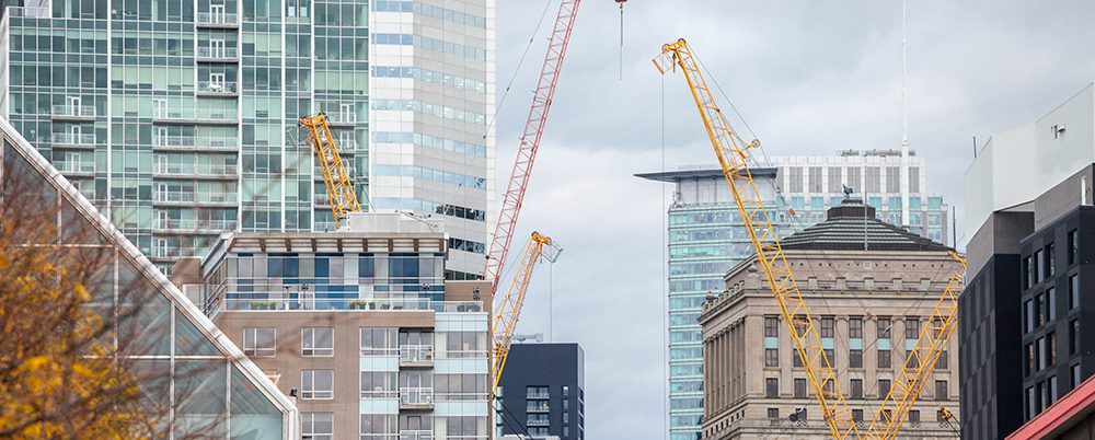 AdobeStock 259962766 Cranes and building device on a construction site of a skyscraper in downtown Montreal header crop