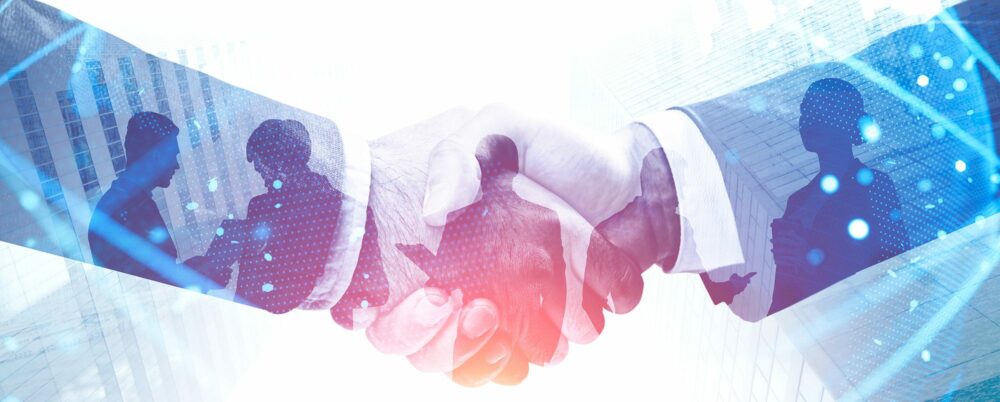 Handshake in city, international partnership Stock image of handshake used to represent public-private partnerships